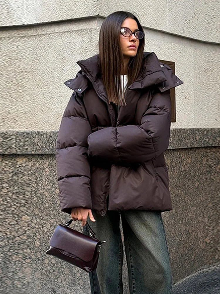 Warm long women's winter jacket made of cotton with hood and stand-up collar