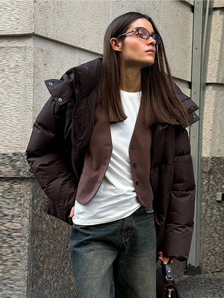 Warm long women's winter jacket made of cotton with hood and stand-up collar