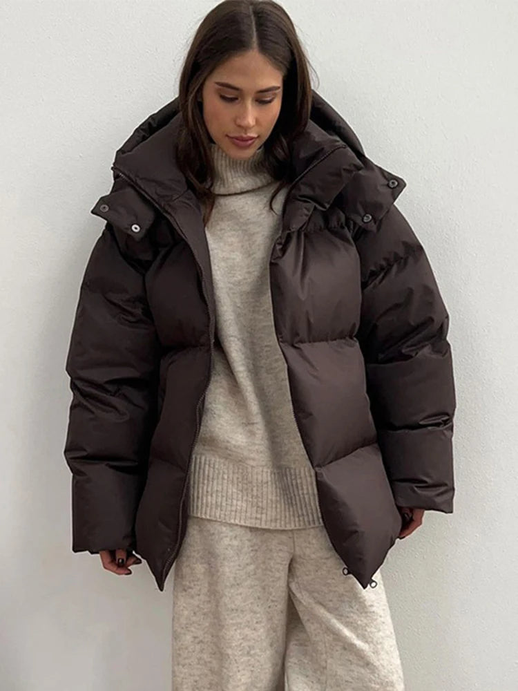 Warm long women's winter jacket made of cotton with hood and stand-up collar