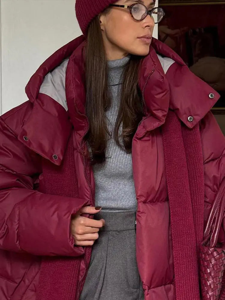 Warm long women's winter jacket made of cotton with hood and stand-up collar