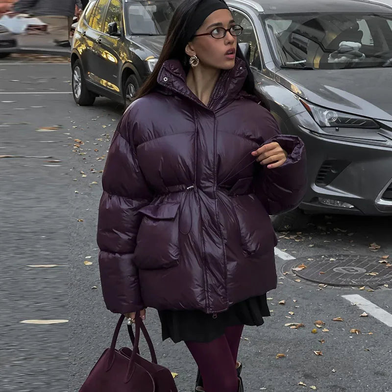 Warm long women's winter jacket made of cotton with hood and stand-up collar