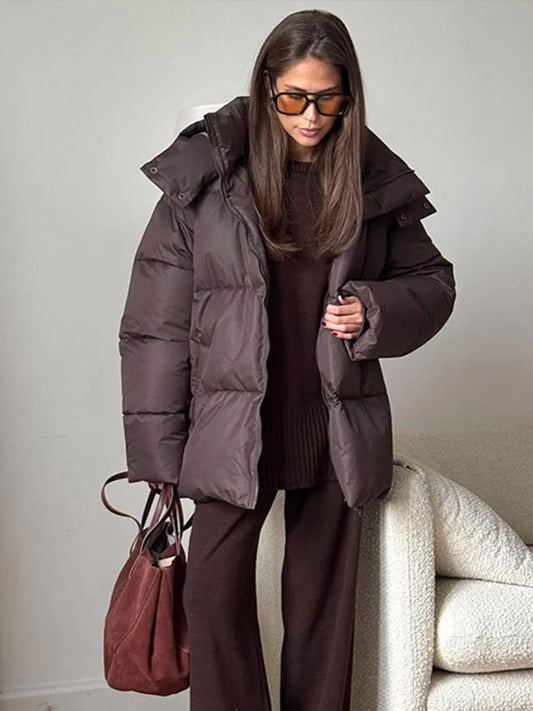 Warm long women's winter jacket made of cotton with hood and stand-up collar